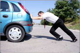 Man pushing a car.